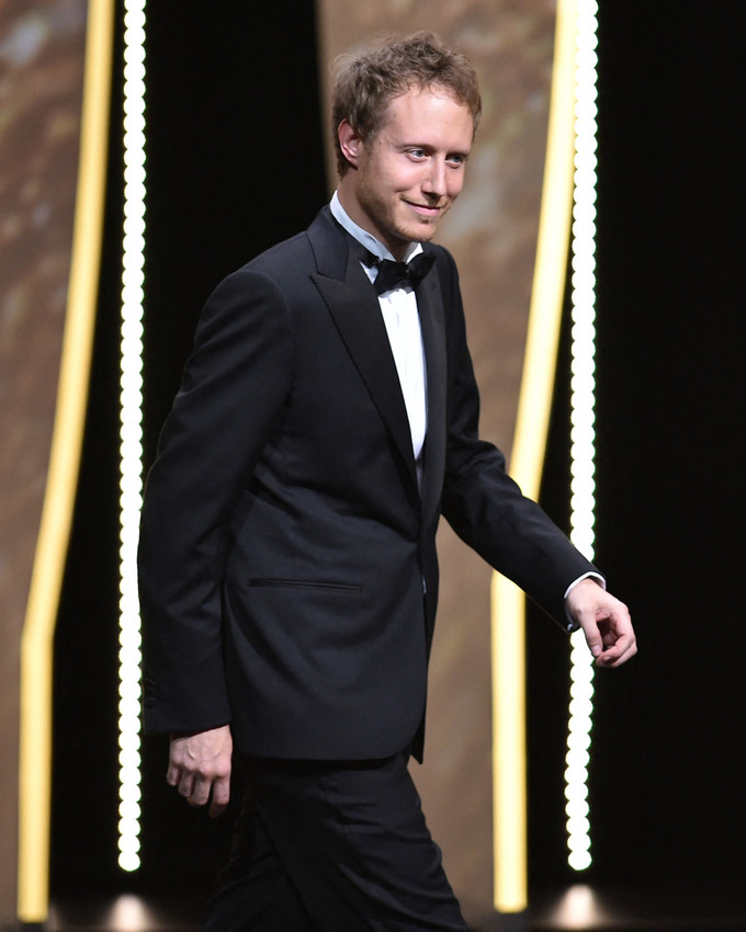 Hungarian director and member of the Jury Laszlo Nemes arrives on stage on May 11, 2016 during the opening ceremony for the 69th Cannes Film Festival, southern France. (Photo by ALBERTO PIZZOLI / AFP)